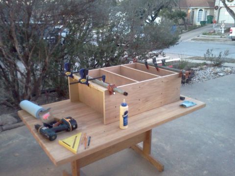 1996 Ford Bronco - A wooden shelving unit is being assembled on a table, with various tools and clamps visible.