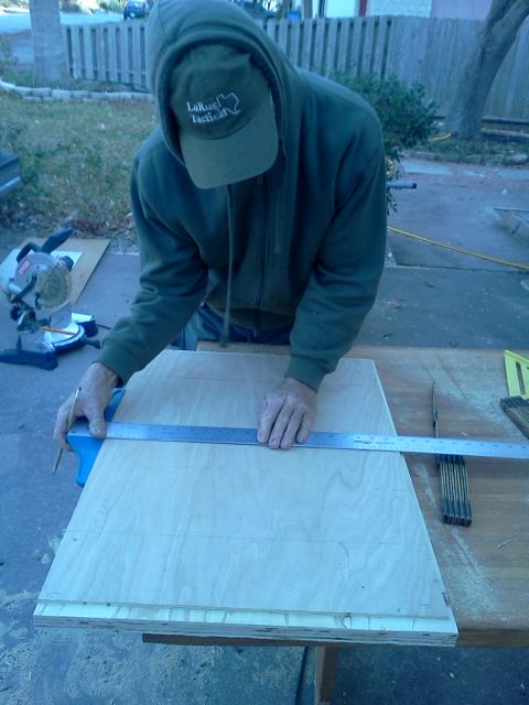 1996 Ford Bronco - A person is carefully measuring and marking a piece of wood for cutting with a ruler and pencil.