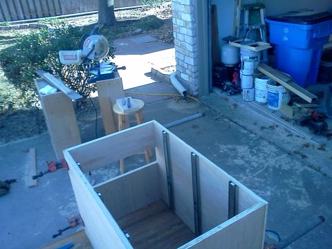 1996 Ford Bronco - Construction scene shows a partially built wooden cabinet with tools and materials nearby.