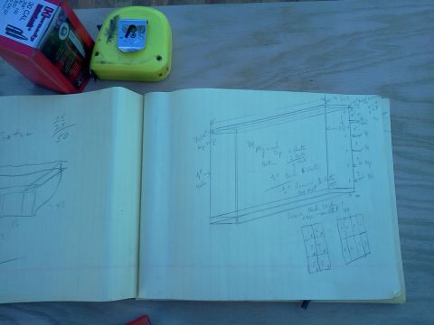 1996 Ford Bronco - Notebook displays diagrams and measurements, possibly for a project, alongside tools.