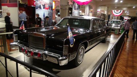 1993 Ford Taurus - A vintage black limousine, possibly a presidential vehicle, is displayed indoors with other vehicles and exhibits.