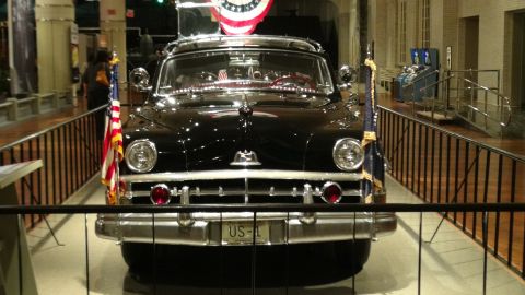 1993 Ford Taurus - A black sedan, possibly a presidential limousine, is displayed with American flags and a US-L license plate.