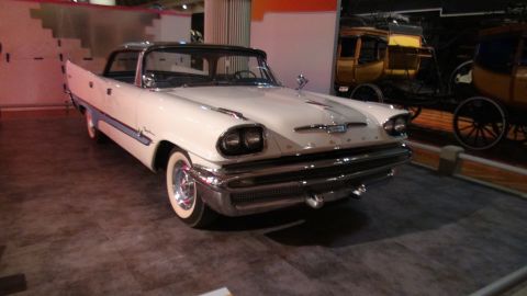 1993 Ford Taurus - A classic white Plymouth Fury is displayed indoors, possibly at a museum or car show.
