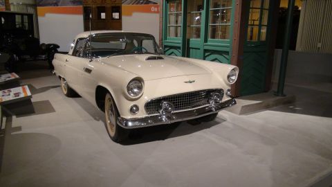 1993 Ford Taurus - A cream-colored 1955 Ford Thunderbird is displayed indoors, possibly in a museum setting.