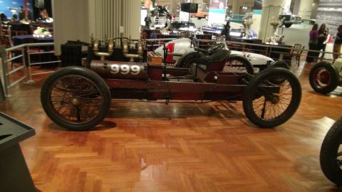 1993 Ford Taurus - A vintage race car with exposed engine components is displayed indoors.