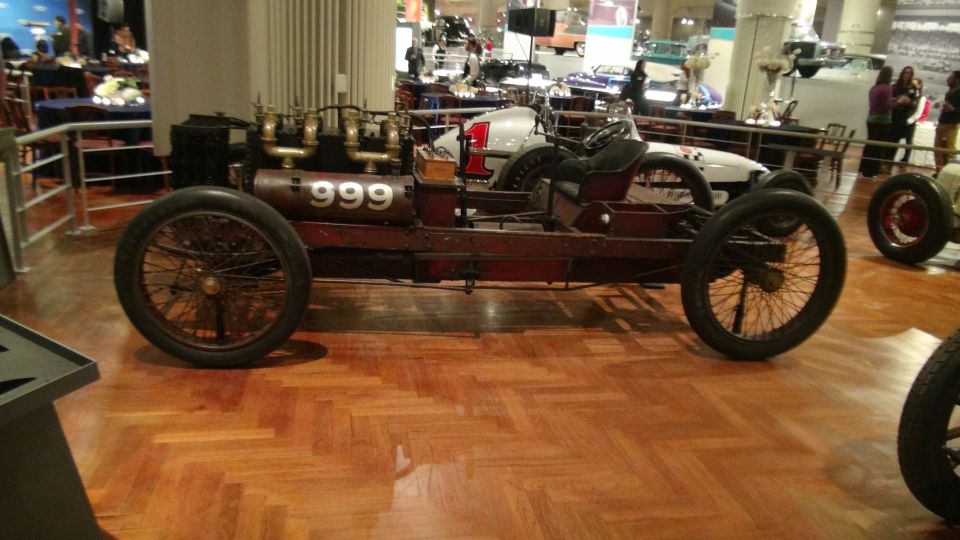 Red race car with wire wheels and number 999 on its side