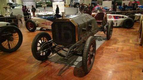 1993 Ford Taurus - An antique race car with a prominent grille displaying the number 16 is seen at a museum alongside other vintage vehicles.
