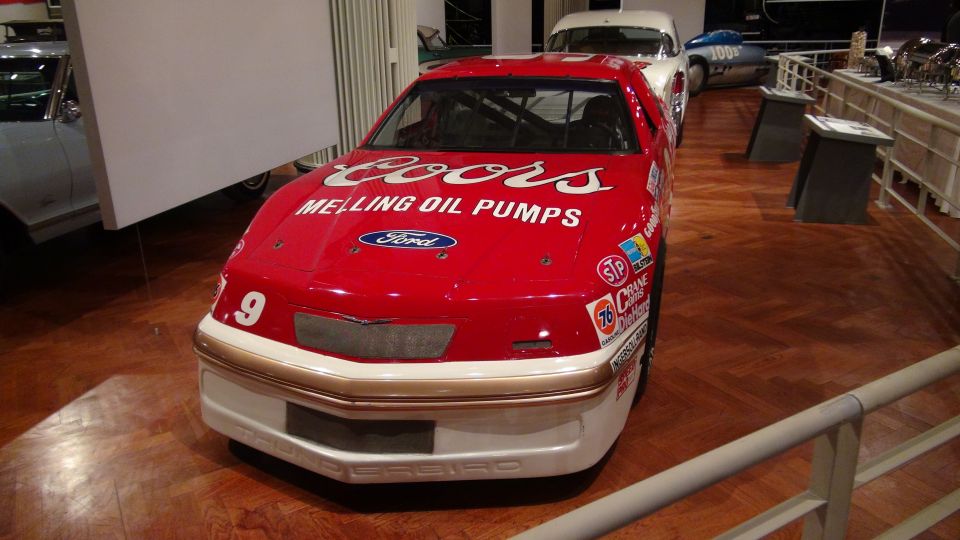 Front view of a red race car with Coors and Melling Oil Pumps logos. Number 9 is visible