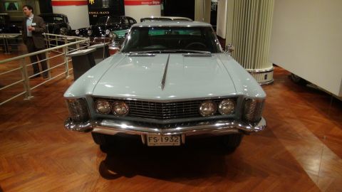 1993 Ford Taurus - A light blue 1963 Buick Riviera is displayed in a museum with other vehicles in the background.