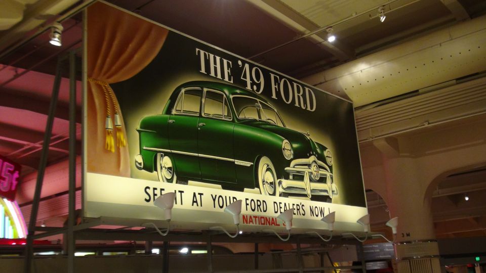 Advertisement for '49 Ford, green sedan, 3/4 front view
