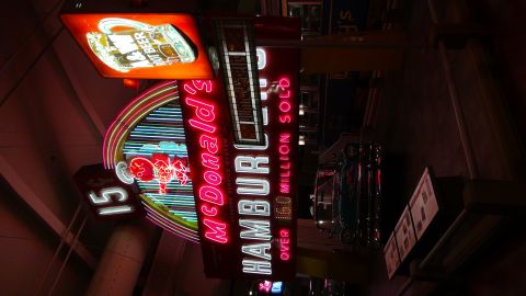1993 Ford Taurus - A bright McDonald's neon sign displays "Hamburgers Over 160 Million Sold" alongside the iconic golden arches.