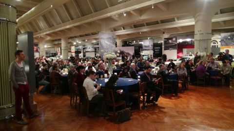 1993 Ford Taurus - An indoor event with many people seated at tables, and vehicles visible in the background.