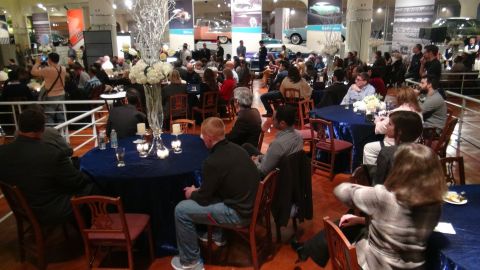 1993 Ford Taurus - Attendees gather at tables decorated with floral arrangements during an event at a museum.