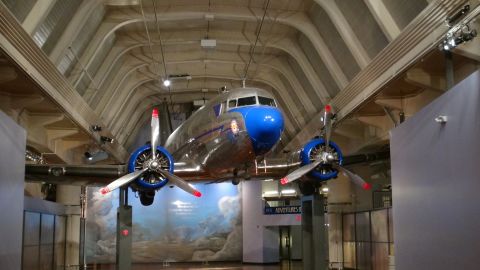 1993 Ford Taurus - A douglas dc-3 airplane is suspended from the ceiling of a museum hall.