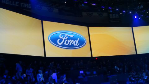 1993 Ford Taurus - A large screen displays the Ford logo during an event.
