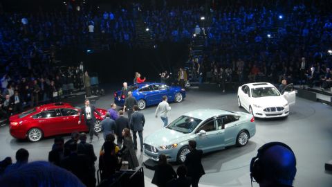 1993 Ford Taurus - Several cars are presented on a stage with a large audience in the background.