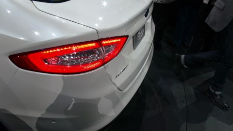1993 Ford Taurus - Rear view of a white Ford Fusion, highlighting its distinctive LED taillights and model badging.