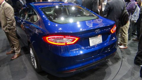 1993 Ford Taurus - Blue Ford sedan with distinctive taillights and a Ford emblem on the rear.
