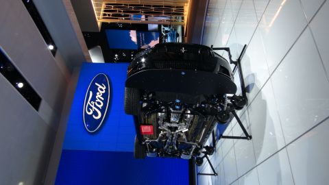 1993 Ford Taurus - A black Ford Mustang is displayed with its rear facing the camera, revealing its exhaust system and undercarriage.