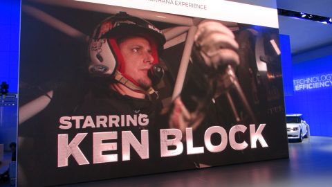 1993 Ford Taurus - Ken Block is featured in a promotional display, with a white Ford SUV in the background.