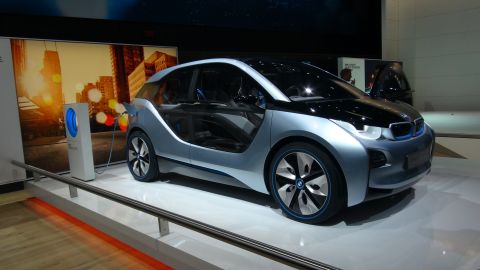 1993 Ford Taurus - BMW i3 concept electric car charging at an auto show display.