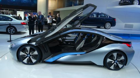 1993 Ford Taurus - A futuristic silver BMW i8 concept car is displayed with its doors open, revealing its interior.