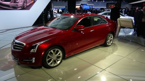 1993 Ford Taurus - A red sedan is displayed indoors on a polished floor, likely at an auto show.