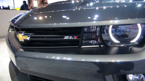 1993 Ford Taurus - Close-up of a Chevrolet Camaro ZL1's front grille and headlight, showing the ZL1 badging and distinctive halo light.