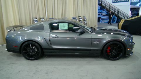 1993 Ford Taurus - A gray Ford Mustang Shelby GT500 is displayed indoors with a window sticker visible.