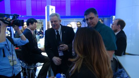 1993 Ford Taurus - Attendees and media interact at an auto show event.