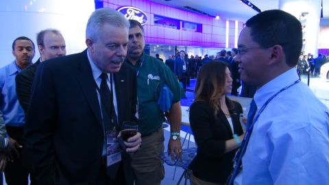 1993 Ford Taurus - Attendees interact at a Ford auto show event, with a prominent Ford logo visible.