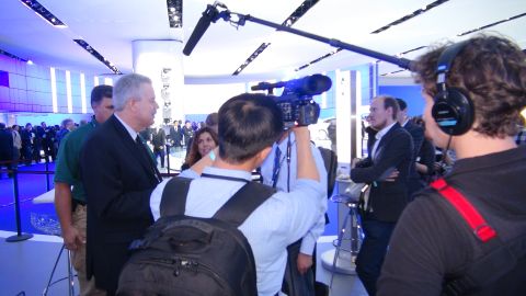 1993 Ford Taurus - A media crew records an event with multiple attendees and professional filming equipment.
