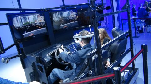 1993 Ford Taurus - A car simulator setup with a person wearing a VR headset driving on screen.