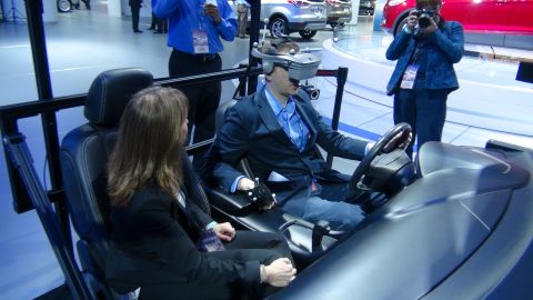 1993 Ford Taurus - Attendees experience a driving simulator at an auto show event.