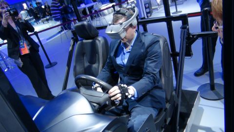 1993 Ford Taurus - A person experiences a virtual reality driving simulation at an event, complete with a steering wheel and motion sensors.