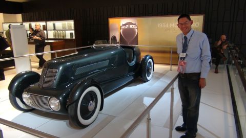 1993 Ford Taurus - A 1934 MG Special is displayed at an auto show, with a man posing beside it.