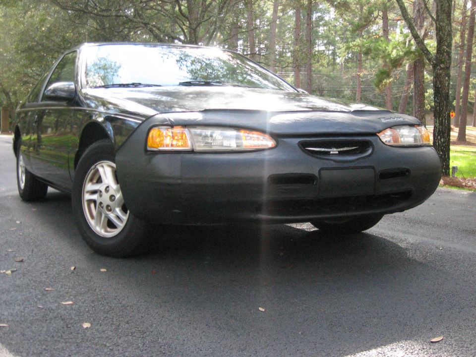 1997 Ford Thunderbird front view with car cover on hood
