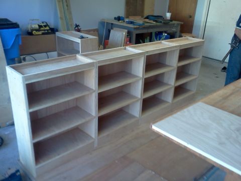 1996 Ford Bronco - Unfinished wooden shelving units are arranged in a workshop, with tools and materials visible in the background.