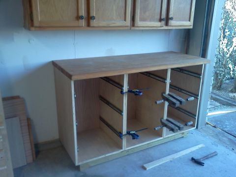 1996 Ford Bronco - Workbench cabinet construction in progress, showing drawer slide installation and clamps.