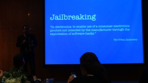 1993 Ford Taurus - A presentation screen shows the definition of 'Jailbreaking' with a speaker and audience visible.