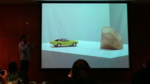 1993 Ford Taurus - A yellow toy car is displayed on a white surface next to a large, faceted object.
