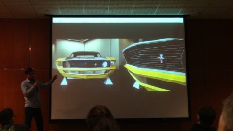 1993 Ford Taurus - Presentation showing a 1969 Ford Mustang front end and grille on a projector screen.
