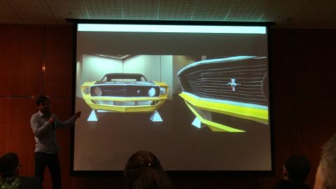 1993 Ford Taurus - A presentation displays a yellow 1969 Ford Mustang from the front and a close-up of its grille.