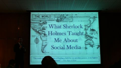 1993 Ford Taurus - A presentation slide displays the title 'What Sherlock Holmes Taught Me About Social Media' over a world map graphic.
