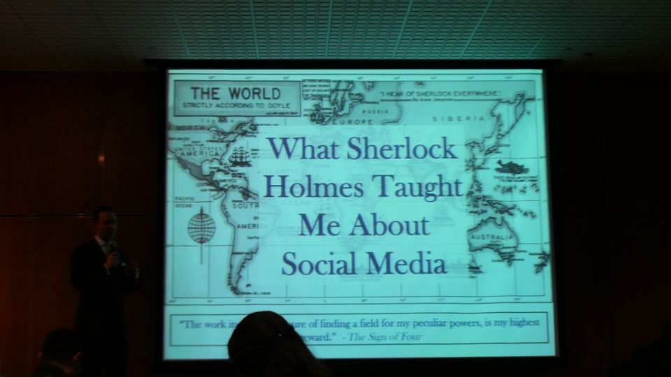 Presentation slide titled 'What Sherlock Holmes Taught Me About Social Media' with a world map