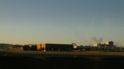 1993 Ford Taurus - A wide shot of industrial buildings against a sunset sky.