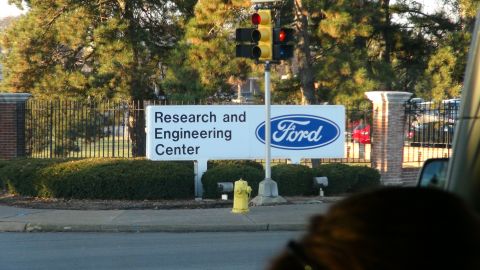 1993 Ford Taurus - A sign for the Ford Research and Engineering Center is visible behind a fence and bushes.