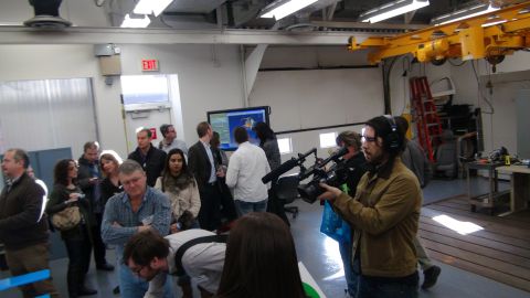 1993 Ford Taurus - A group of people observe a presentation on a large screen in what appears to be a workshop or lab environment.