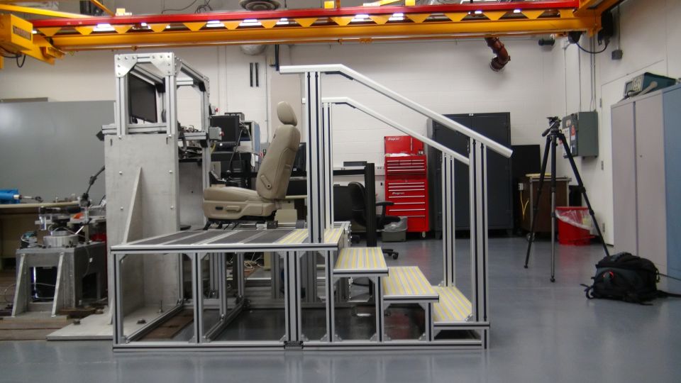 Car seat on a test rig with stairs and monitors