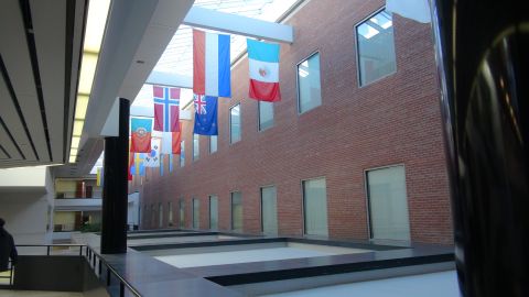 1993 Ford Taurus - An indoor space with a skylight, brick walls, and numerous international flags displayed.